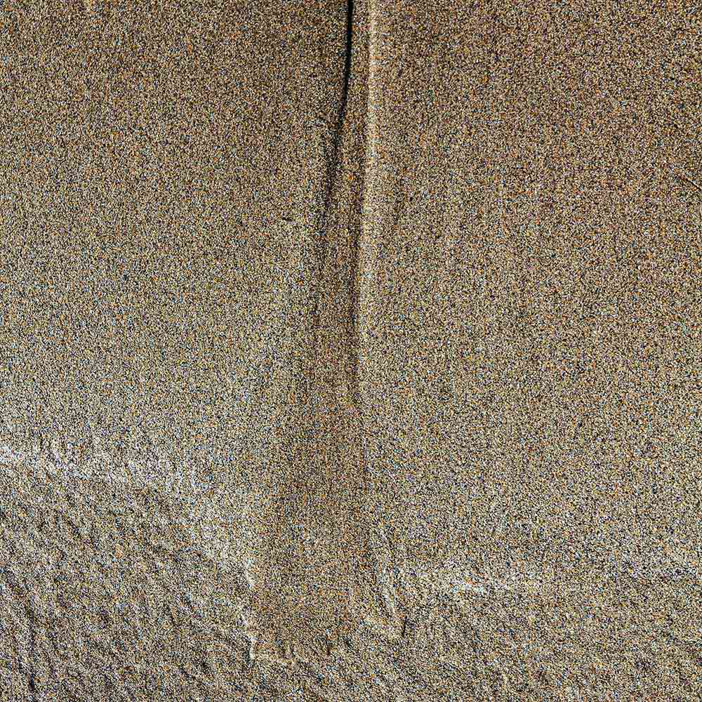 strands | A funnel of sand made by receding salt water, and shadows on a Breton beach