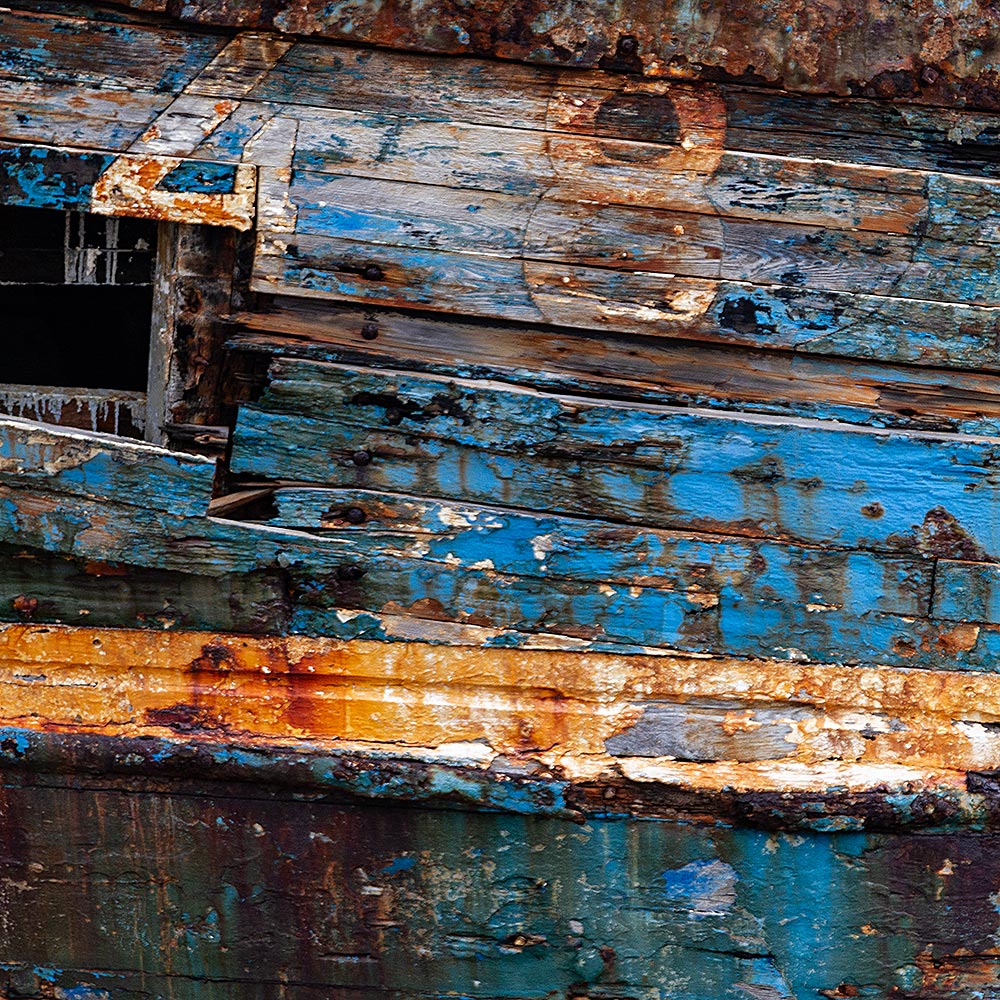 Camaret-sur_mer | The registration number 48 on side of a rotting hulk of a fishing boat with peeling rusty blue, black and yellow paint